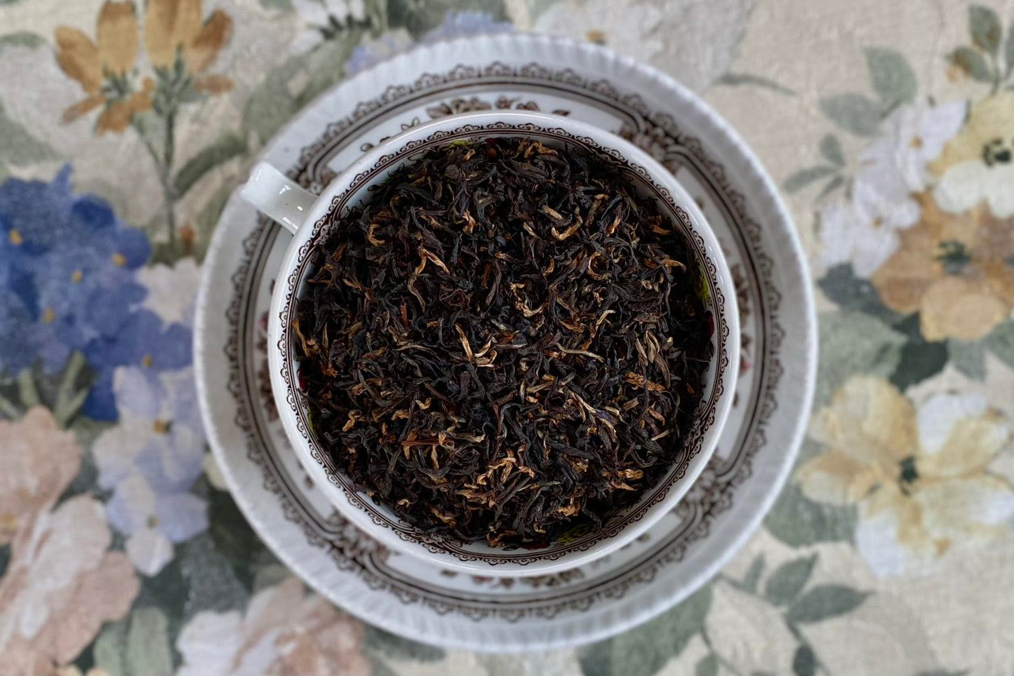 teacup full of black tea with golden tips
