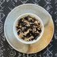 Teacup full of tea leaves and spices