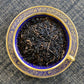 Teacup full of dark tea leaves