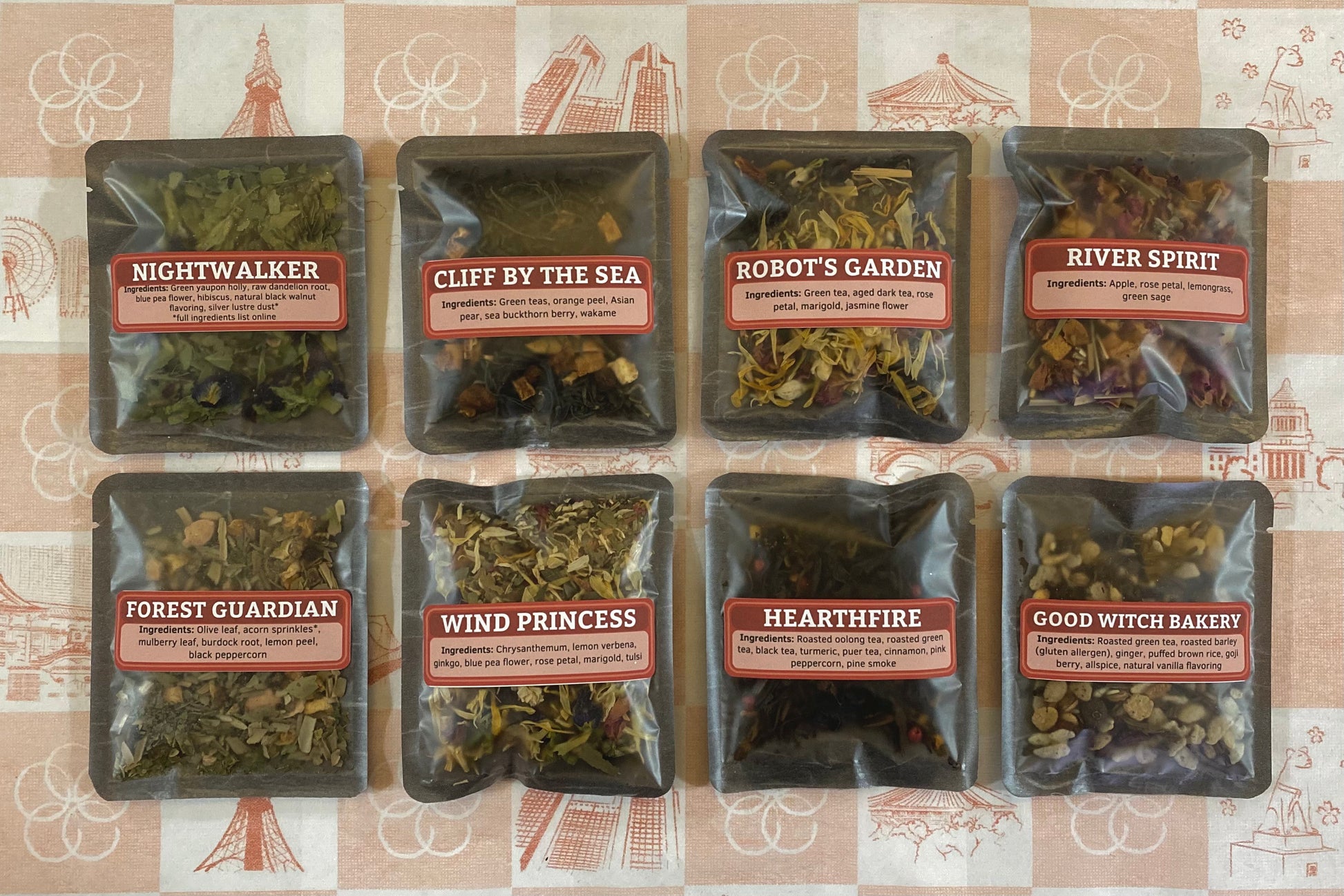 Eight packages of tea with labels on a patterned background