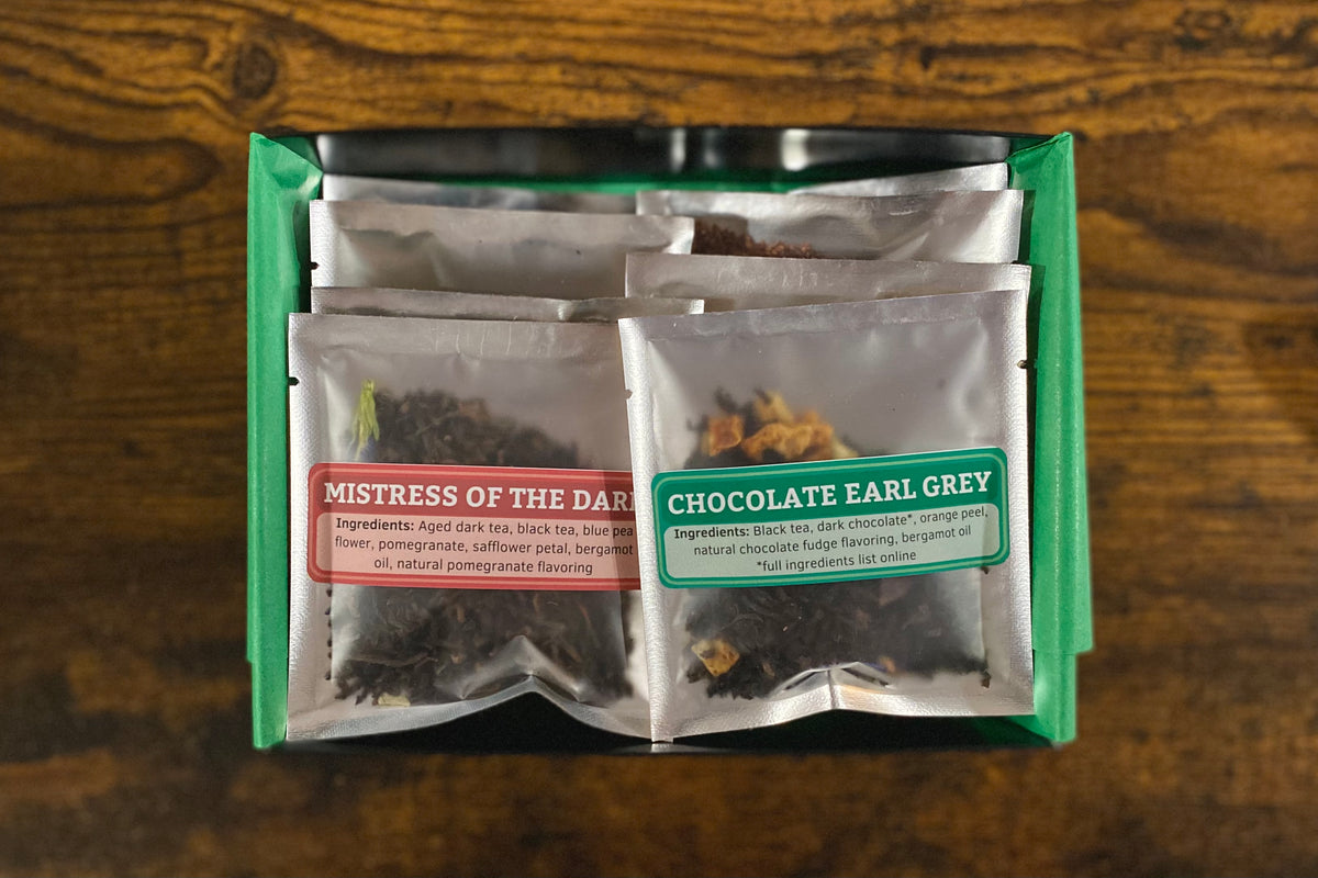 Open box of tea samples with Mistress of the Dark and Chocolate Earl Grey showing