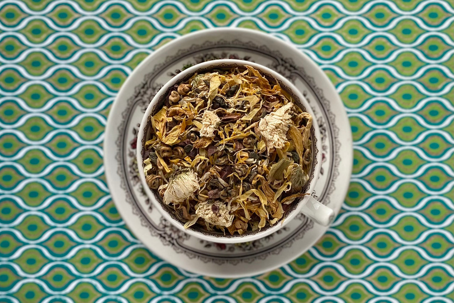 teacup full of sunny flowers, cacao nib and rolled black & green teas