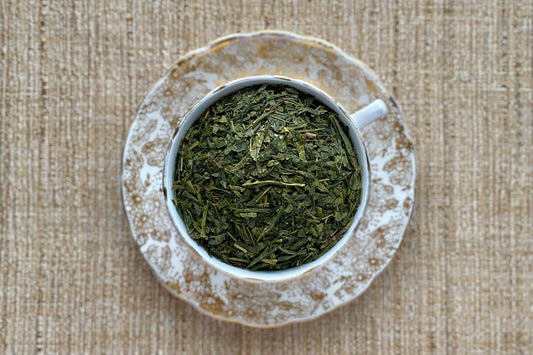 Teacup full of green sencha tea leaf